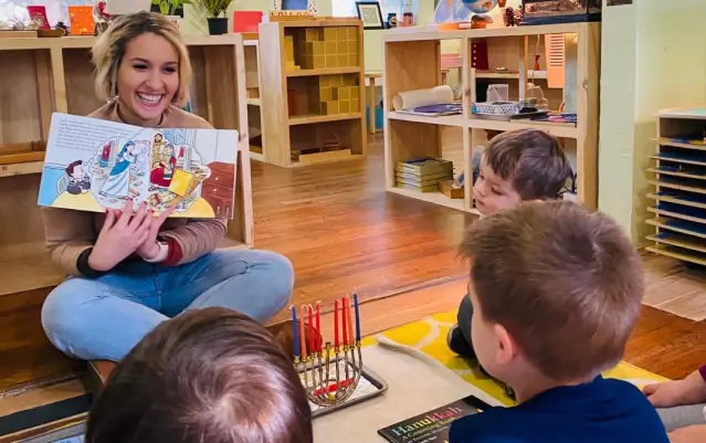 teacher reading to young students