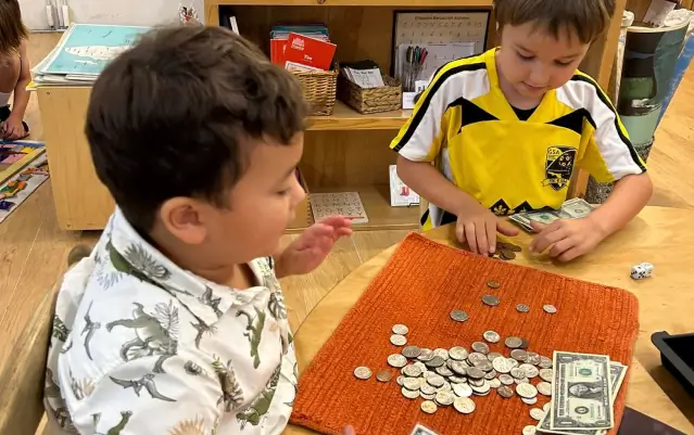 children engaged in a classroom math activity